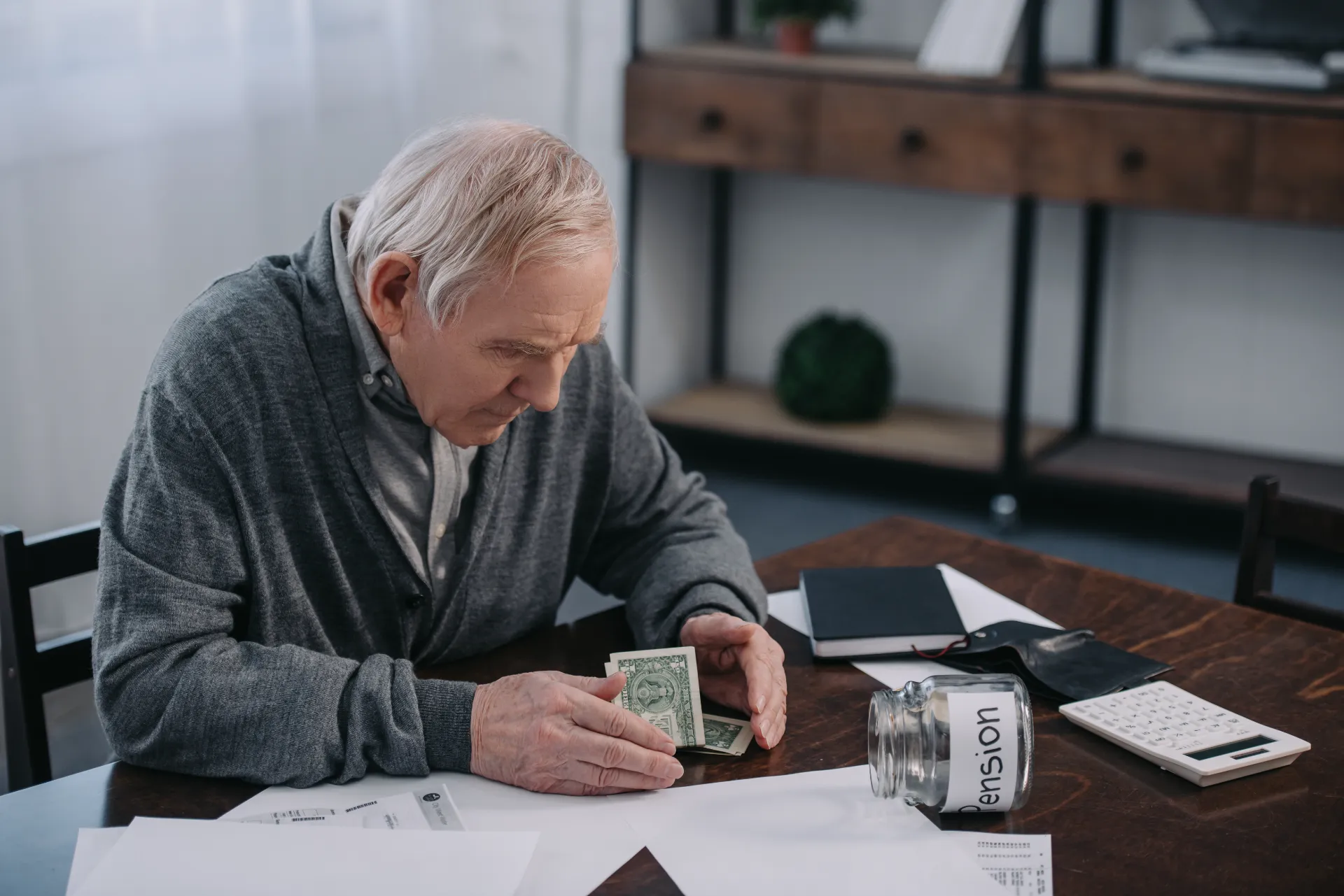 an old man crying over his lost pension due to scams